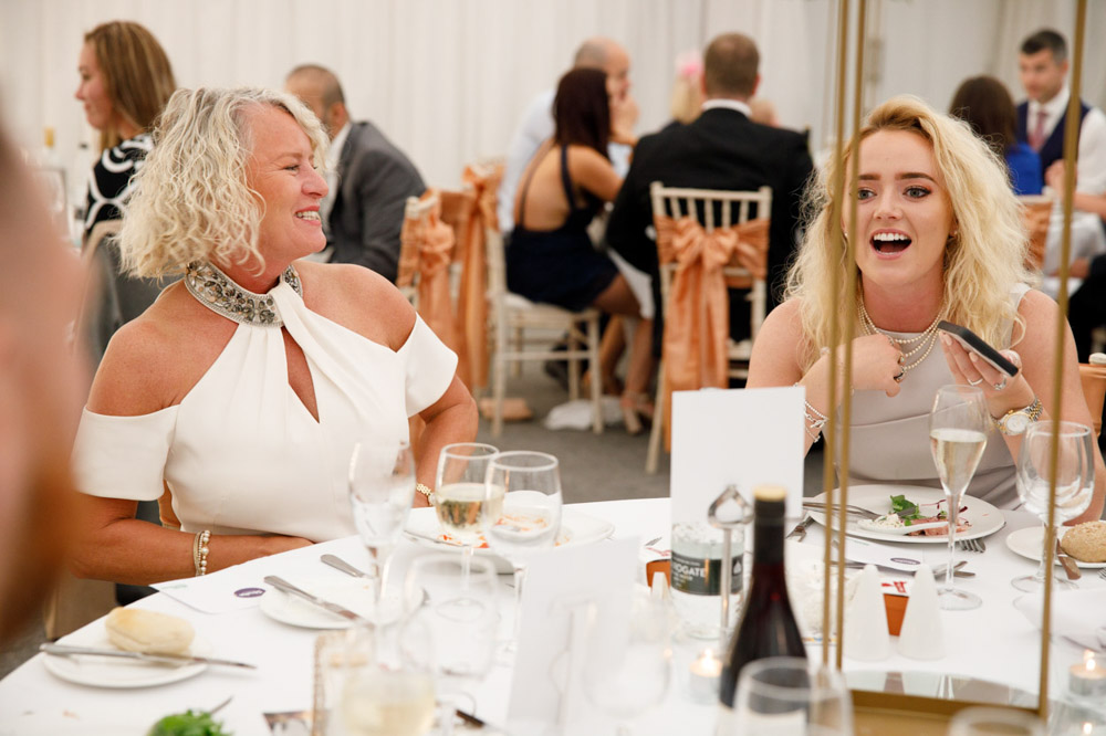 A mother and daughter sat together, laughing openly.