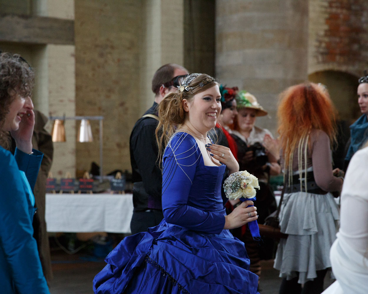 The bride smiles as she takes in the reception setup at Left Bank Leeds