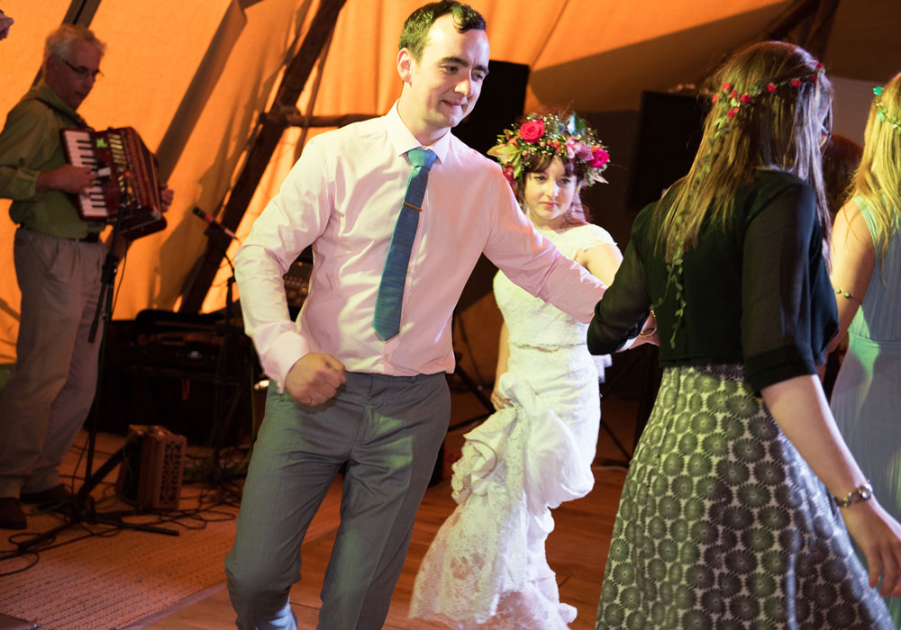 Guests perform energetic ceilidh moves on the dance floor.
