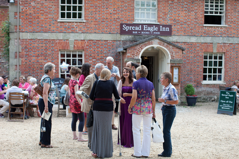 Guests gathered outside The Spread Eagle pub in evening light