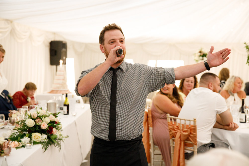 Singing waiter jumps up and starts the surprise performance.