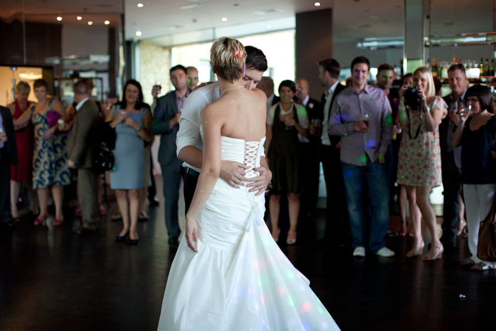 The couple shares a close hug while dancing, caught in a tender moment.