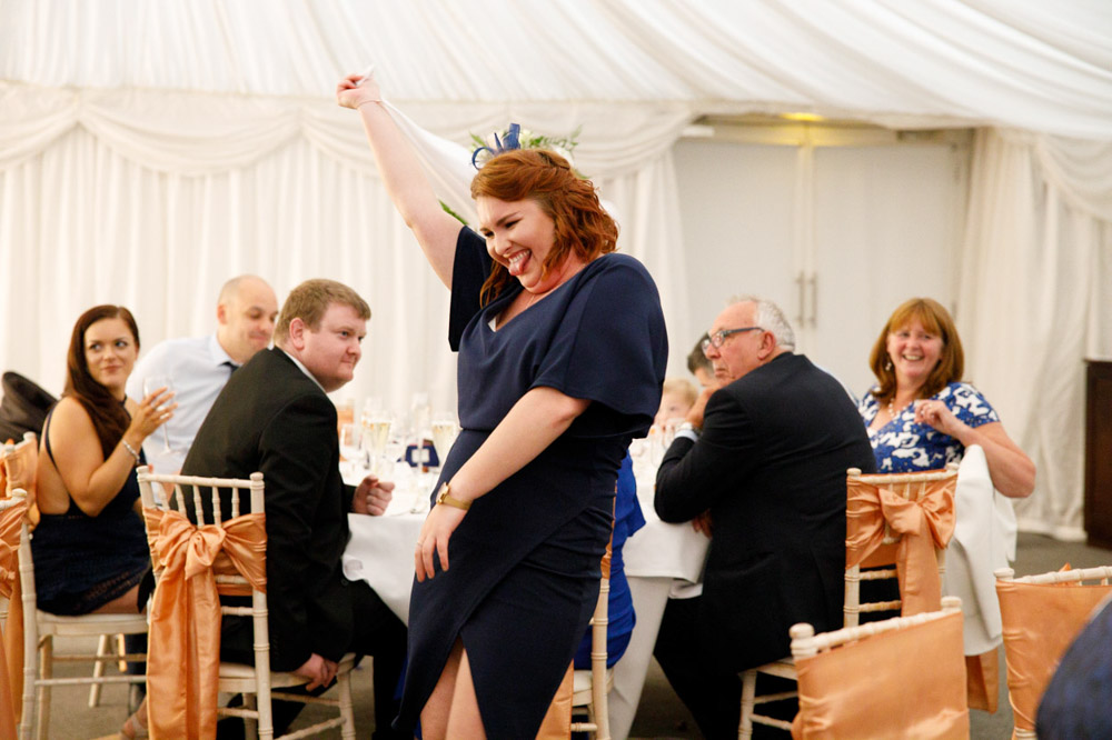 Guest dancing with tongue out, caught in the joy.