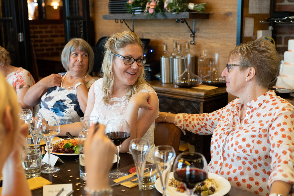 Clare and Tracey finally seated, relaxing with guests