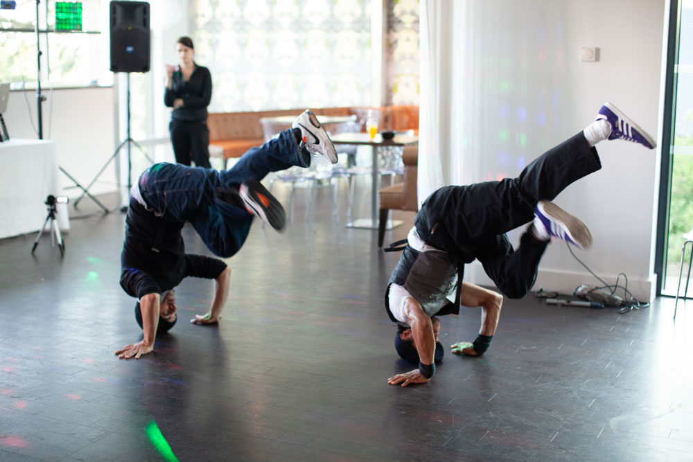 Two breakdancers spin on their heads impressively during the performance.