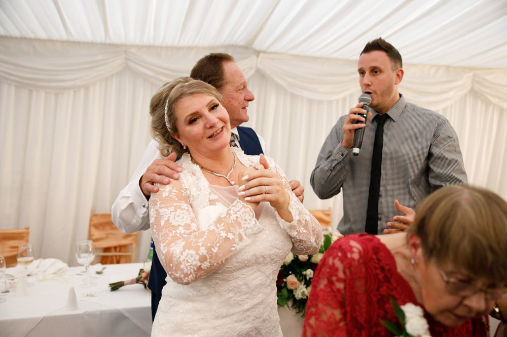 Singing waiter moves closer to Tracy and Gary on the floor.