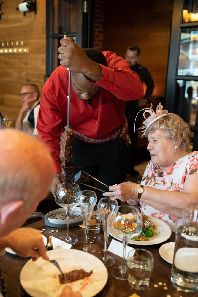 A server slices meat tableside near Grandma
