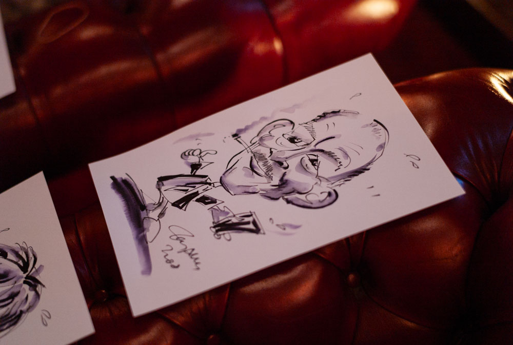 A guest places down their finished caricature with a smile
