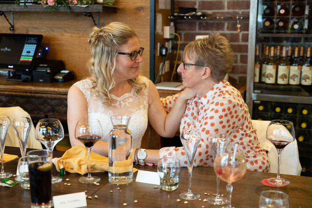 Clare and Tracey casually close with arms gently around each other