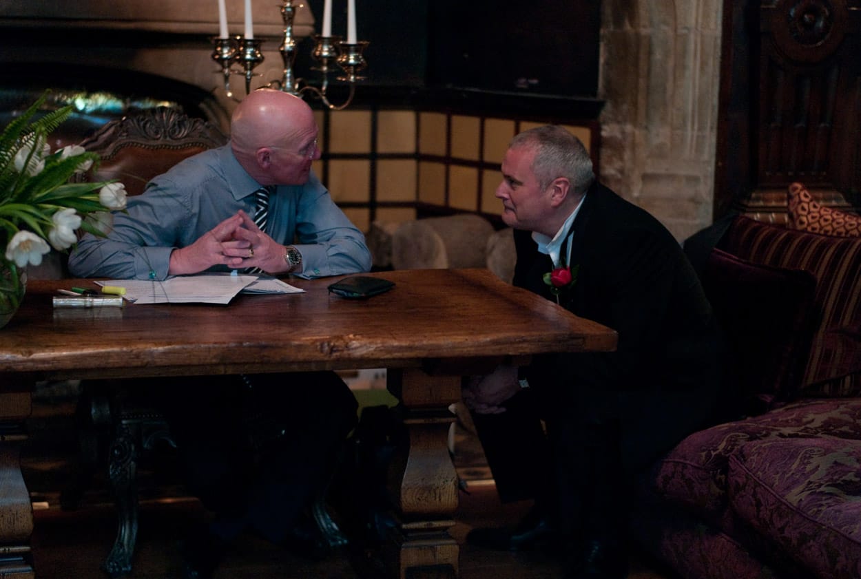 The groom smiling and chatting with the registrar before the ceremony begins.