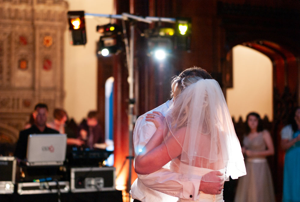 The dance continues beneath glowing lights, the couple lost in the moment