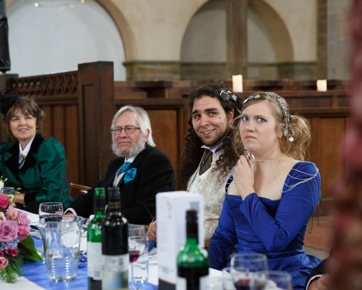 The couple react with mock-accusation and laughter during the speeches