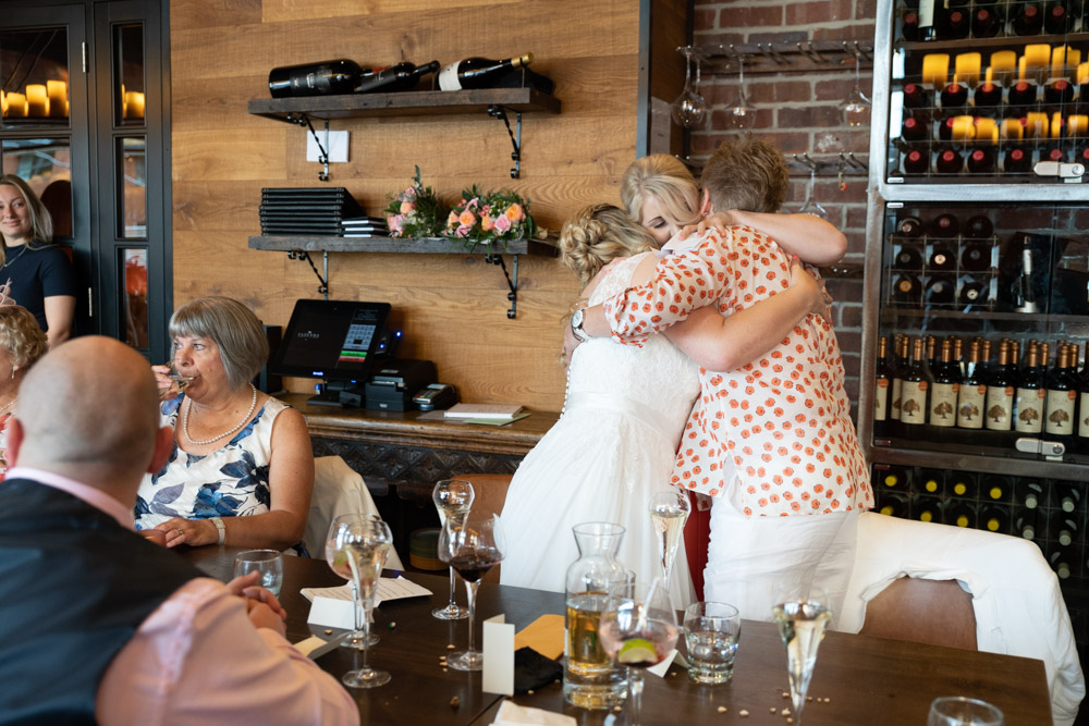 Clare and Tracey hug her daughter after the speech