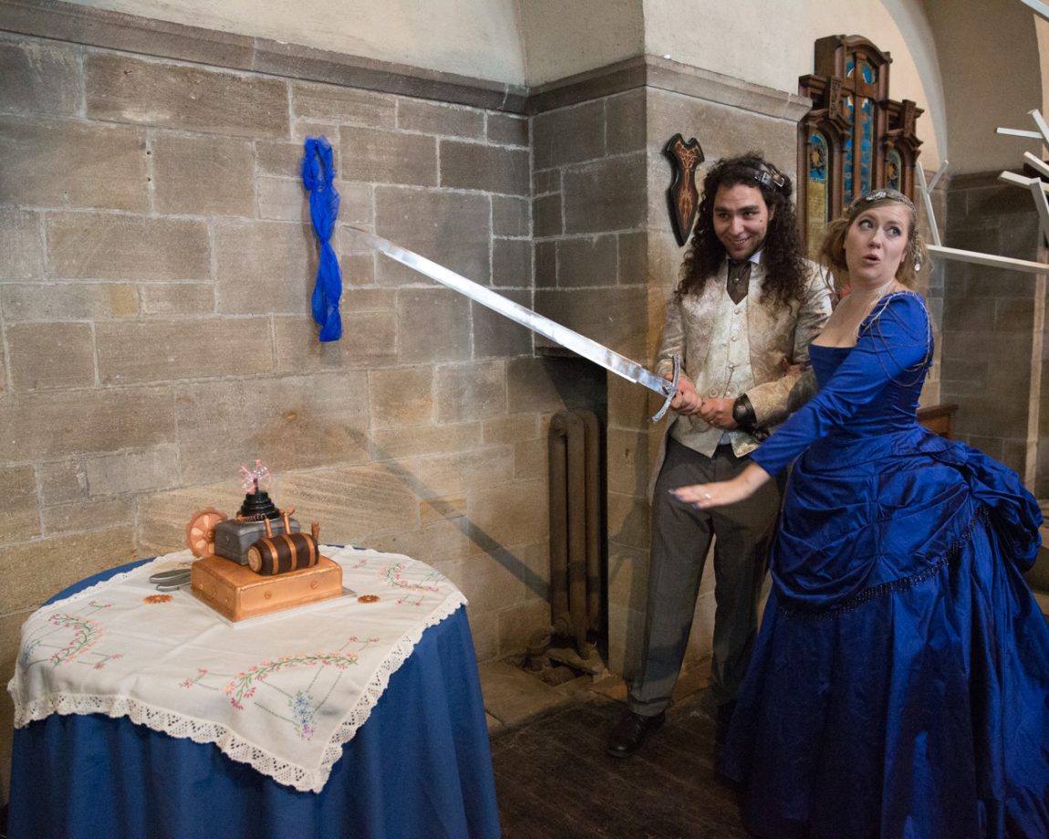 155 the couple hold the sword in preparation of the dramatic cakecutting left bank leeds wedding reception linsey and chris