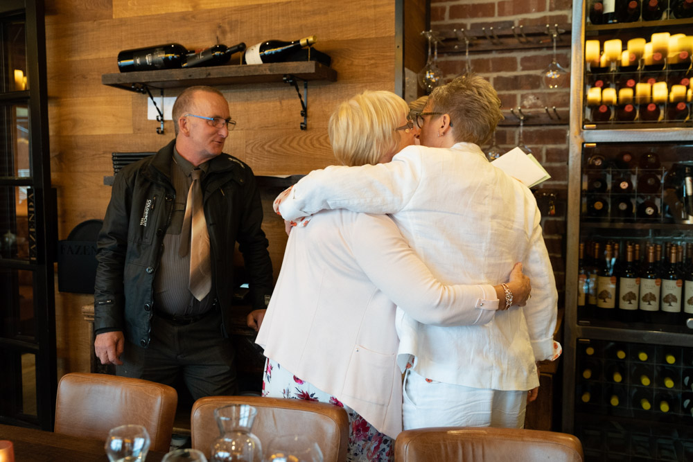 Tracey hugging guests as they leave the celebration