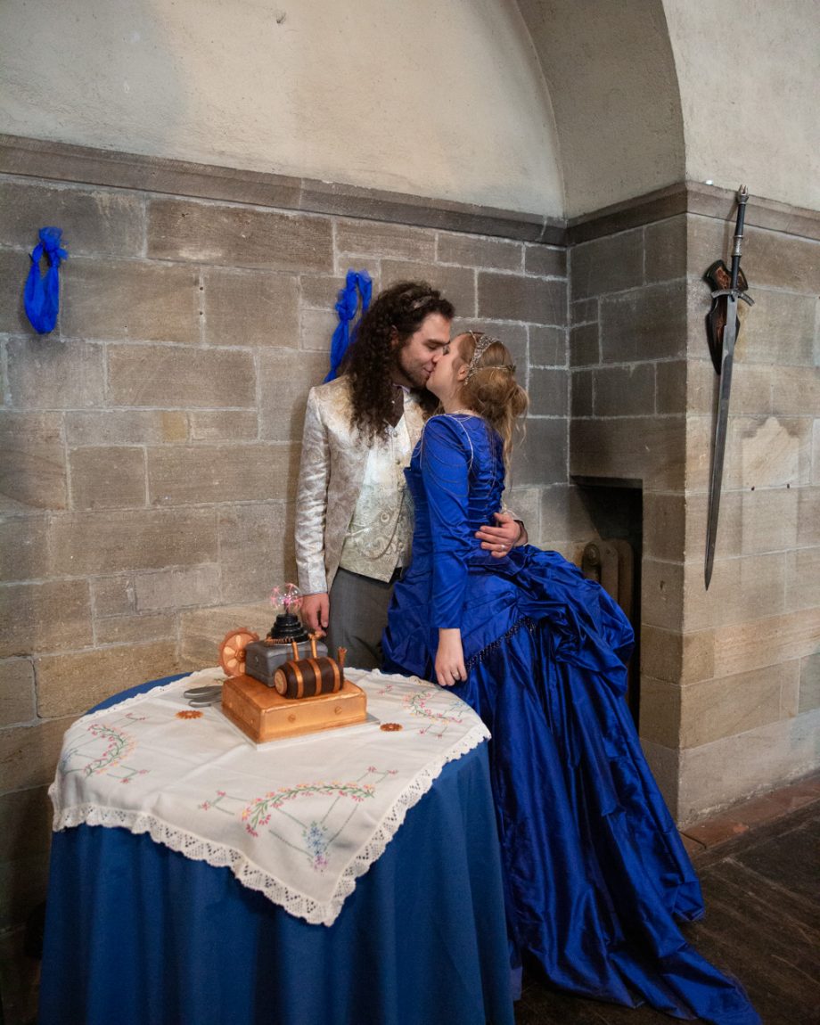 158 the couple kiss by the cake table smiling left bank leeds wedding reception linsey and chris