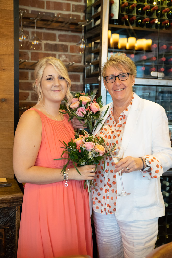 Tracey and Clare’s daughter holding their bouquets