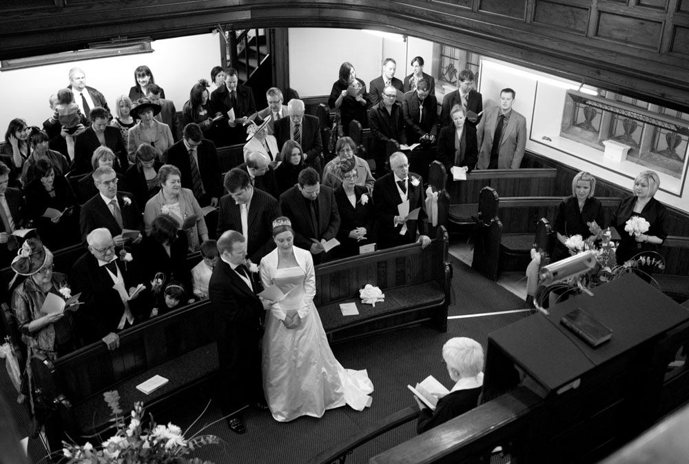 Intimate wedding ceremony seen from the balcony of a small Yorkshire church.