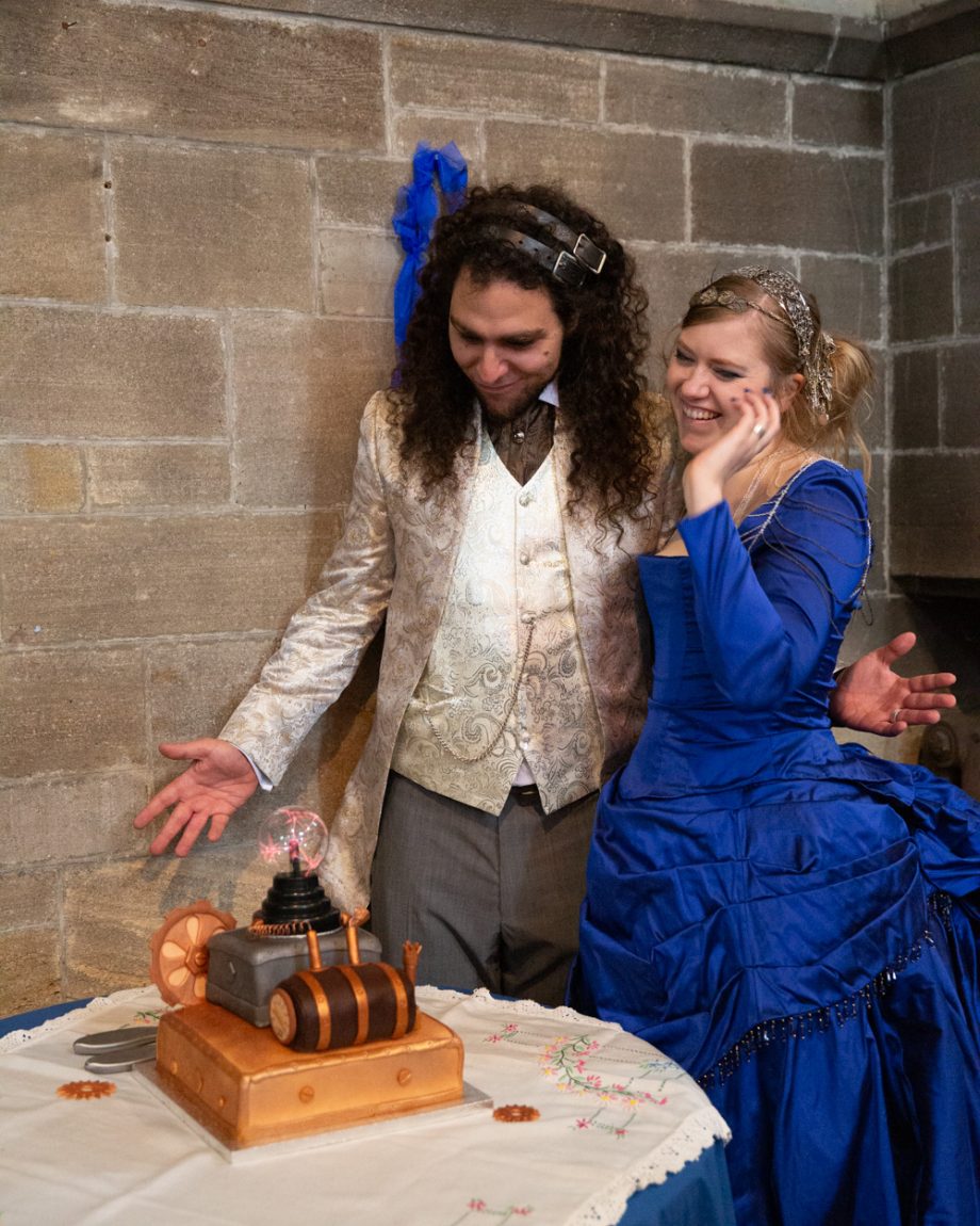 160 they admire their wedding cake theme smiling happily left bank leeds wedding reception linsey and chris