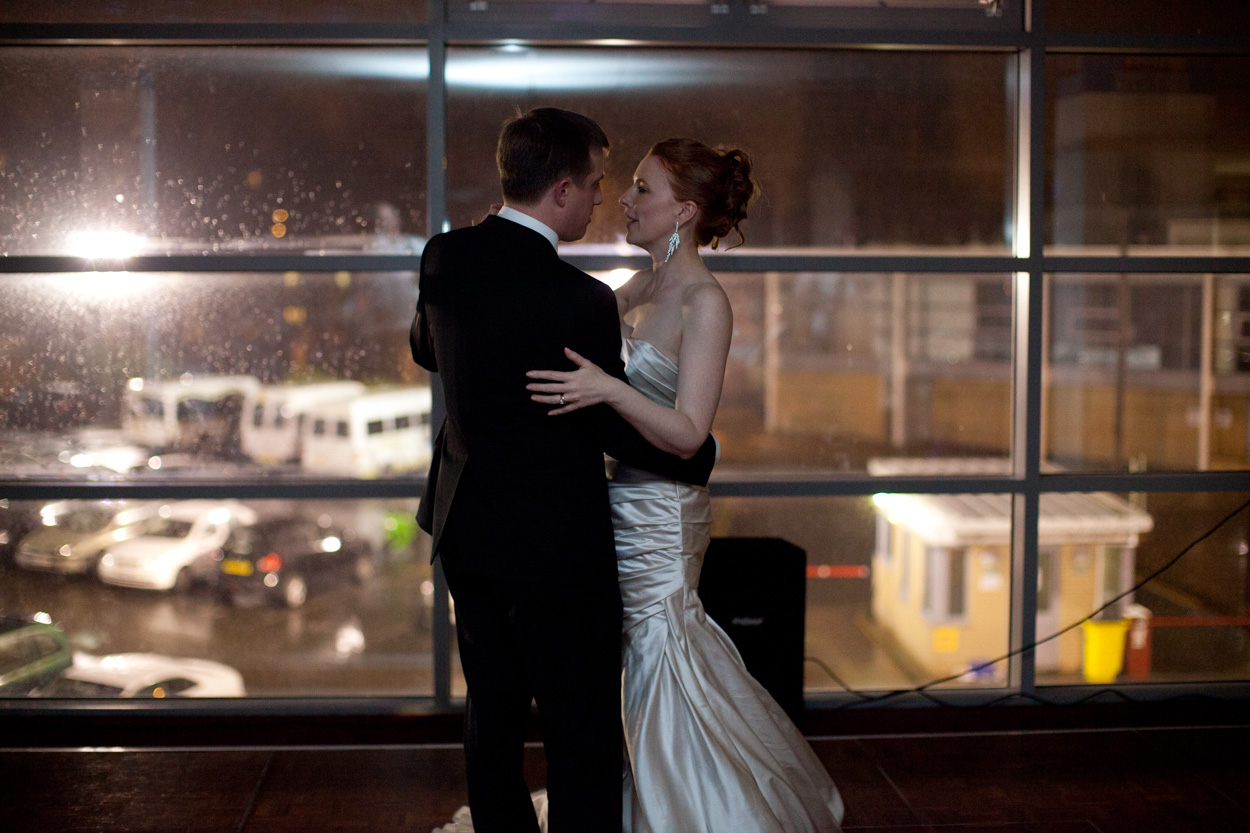 The couple share their first dance at Headingley Stadium, held close against the dark windows and winter night outside.