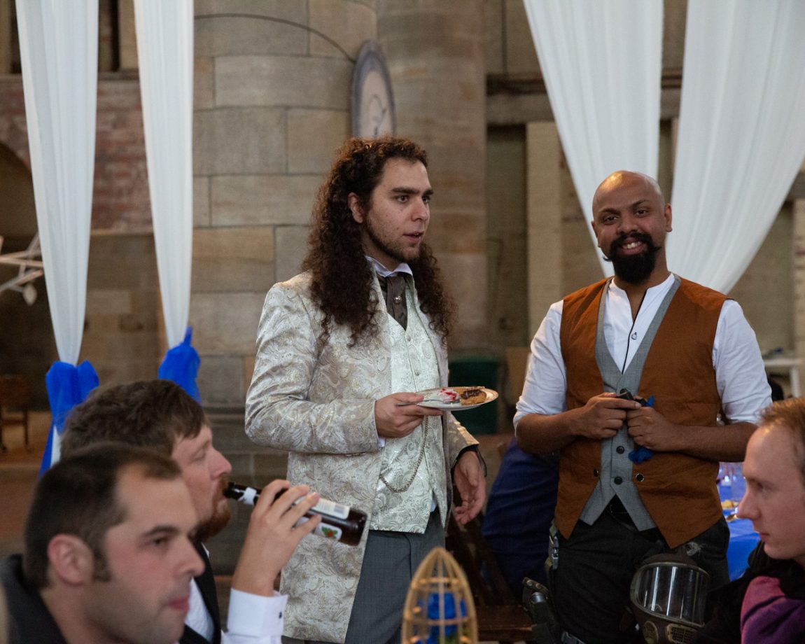 175 groom eats cake chatting with friend left bank leeds wedding reception linsey and chris