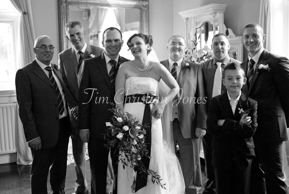 The family turns toward the camera with open, easy smiles after the laughter.