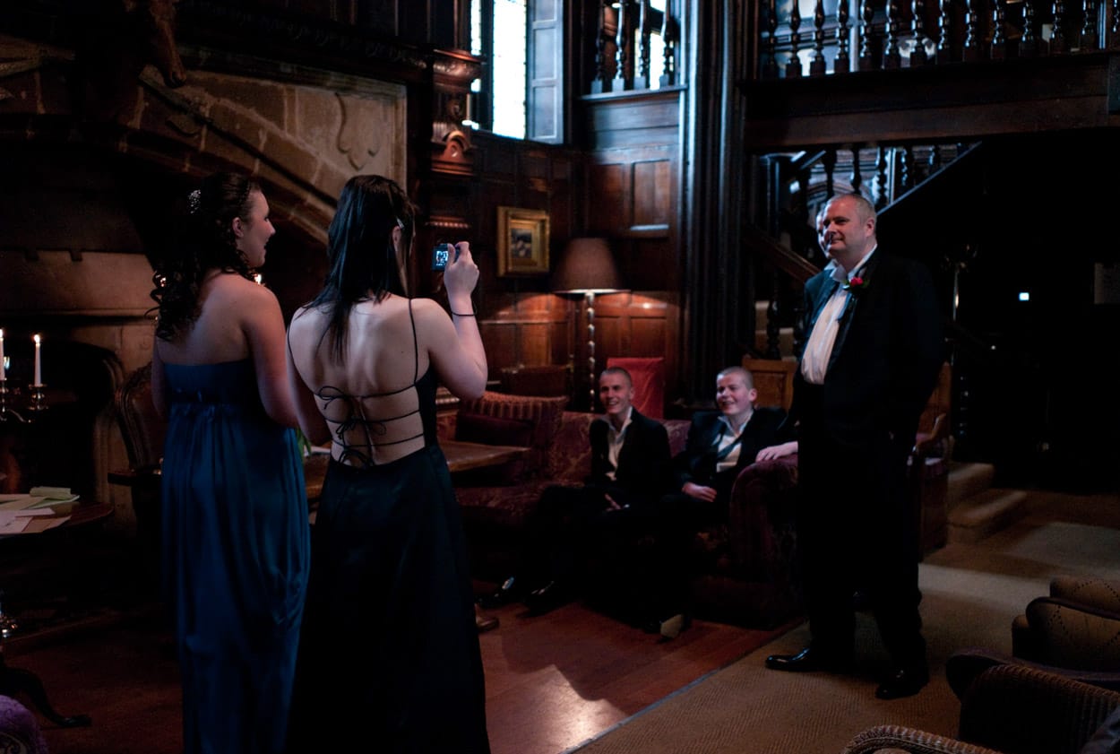 Portrait of the groom posing casually in the warm golden light of Mitton Hall.