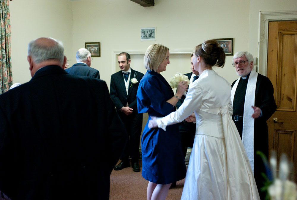 After the ceremony, the bride and groom are hugged in the vestry.
