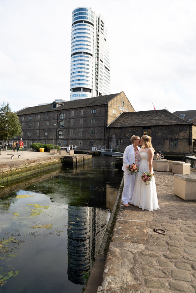 The couple kiss beside the Leeds canal