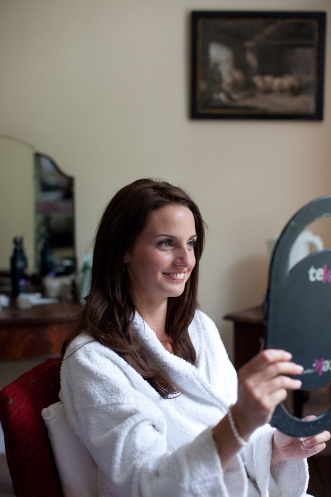 The bride happy and smiling - a reaction to her make up by Wedding photographer Yorkshire