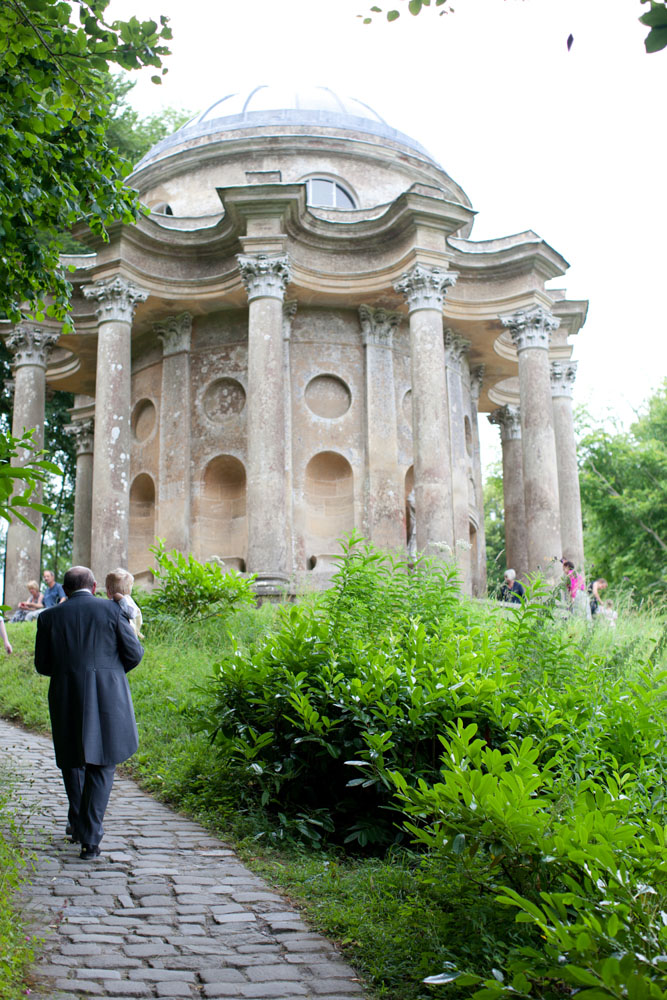 Brides father and son walk up to the Temple of Apollo Stourton