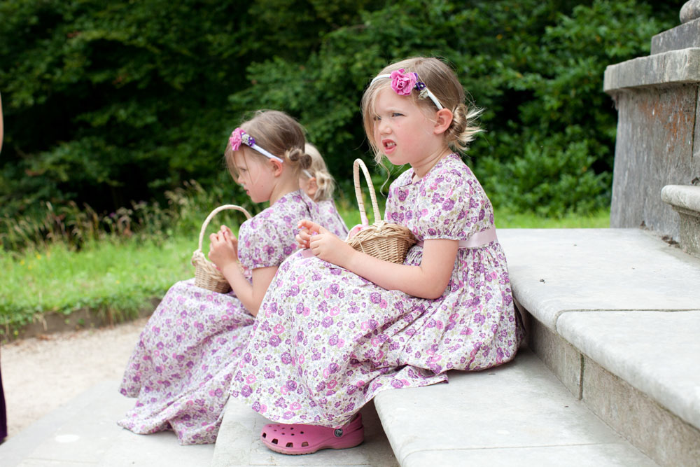 2 flower girls sat on the steps