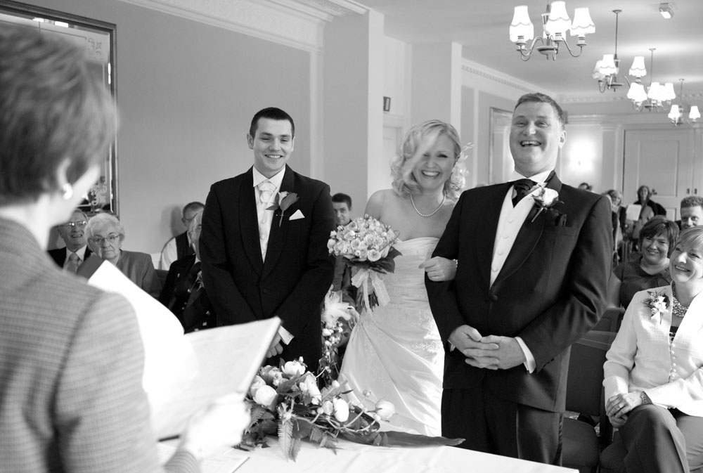 Groom, bride and her father all laugh - Hoyle Court wedding photography