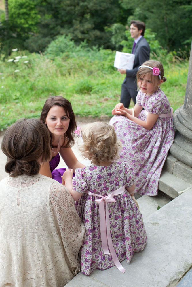 Flower girls chat with a bridesmaid