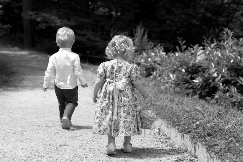 Two children walk down the pathway in black and white - by Leeds, West Yorkshire wedding photographer