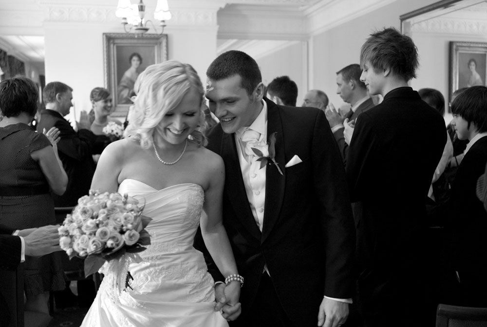 The couple exit in black and white