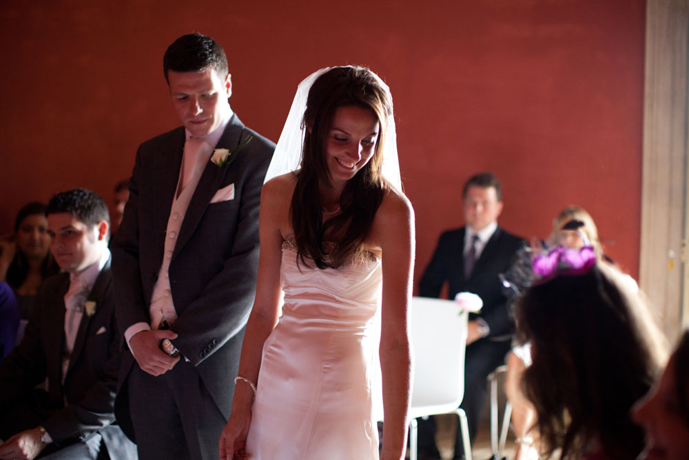 Bride passes her bouquet to the bridesmaid