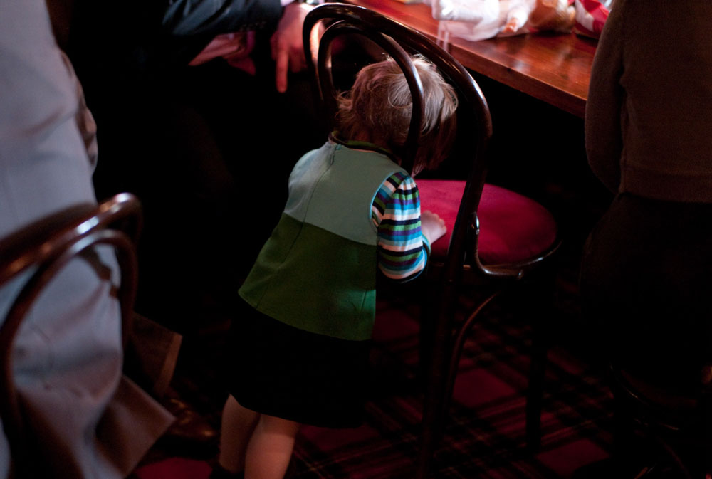 Chile puts her head through the chair back during the wedding breakfast