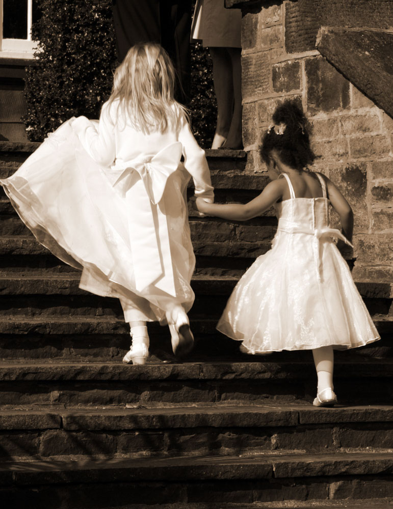 Bridesmaid and her friend walking up the stairs at the venue