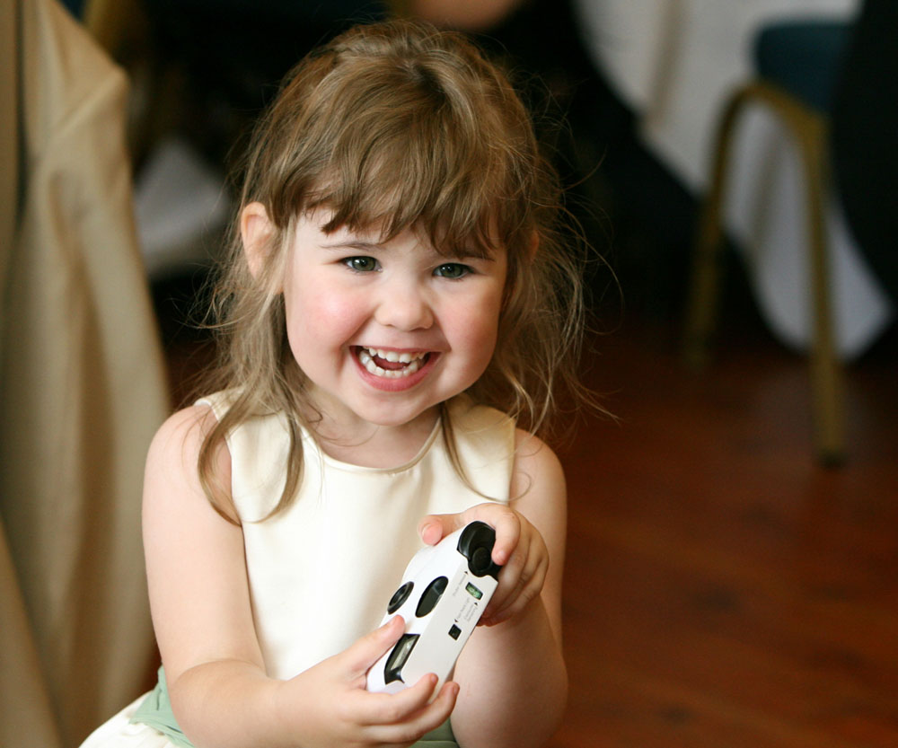 Little bridesmaid loves the disposable camera