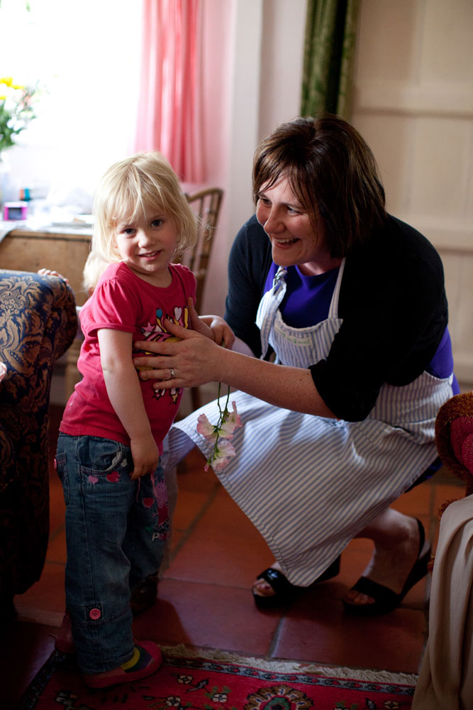 Little one shyly smiles for a photo with her gran - - emotive Yorkshire and Leeds wedding photography