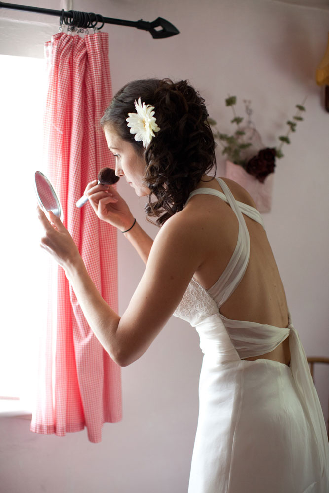 Bride doing make up by the window - emotive Yorkshire and Leeds wedding photography