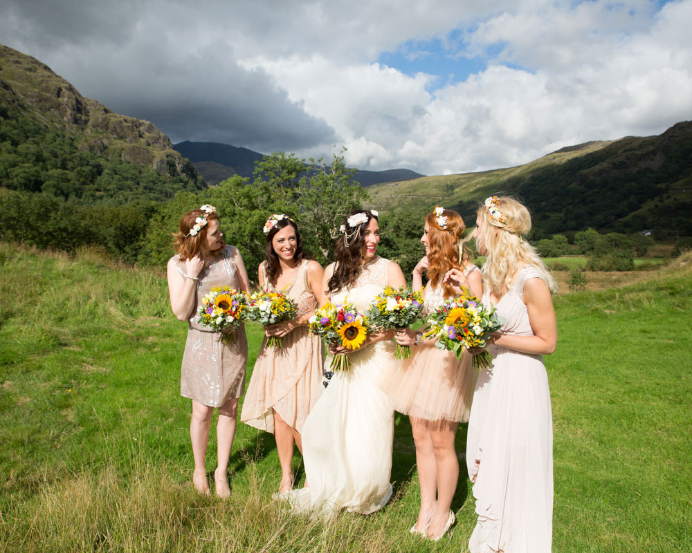 Beautiful dramatic skies group photo of the bride and bridesmaids