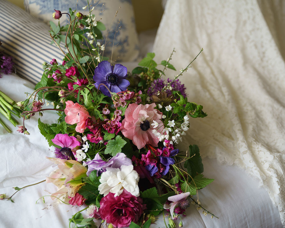 The bridal bouquet placed by the wedding dress for a timeless photo - wedding photography Leeds