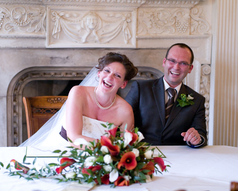 Signing the register fun and laughter by Leeds wedding photographer