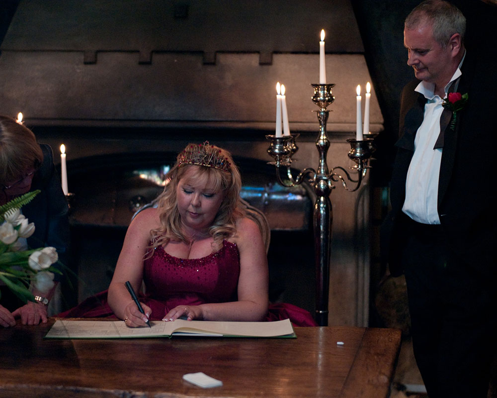 The bride signing the register