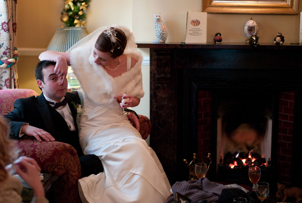 Bride touches the Grooms nose by the open fire