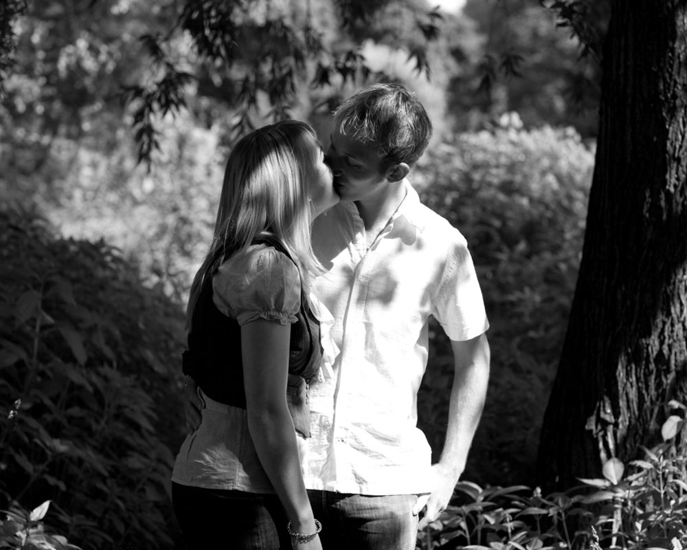 couple kiss at Kirkstall Abbey -  Engagement Photography, so full of Personality