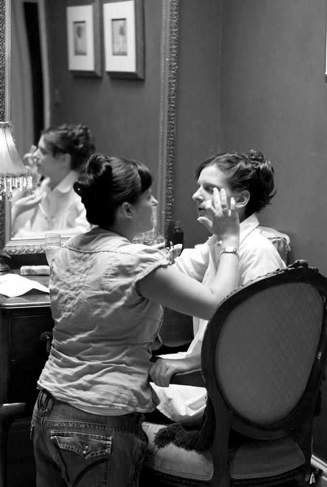 Bride's sister helping with the bride's make up - emotive Yorkshire and Leeds wedding photography