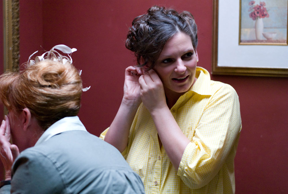 The bride putting her ear rings and smiling